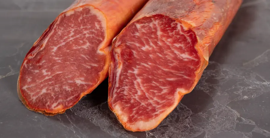 Lonchas de lomo ibérico y lomo embuchado sobre tabla de madera
